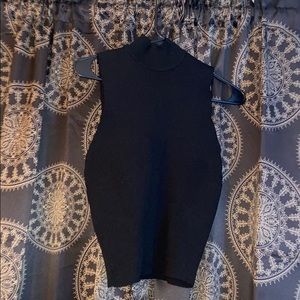 A black sleeveless turtle neck crop top